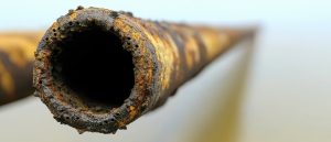 Close Up Of Rusted Metal Pipe Showing Corrosion And Decay With Blurred Background